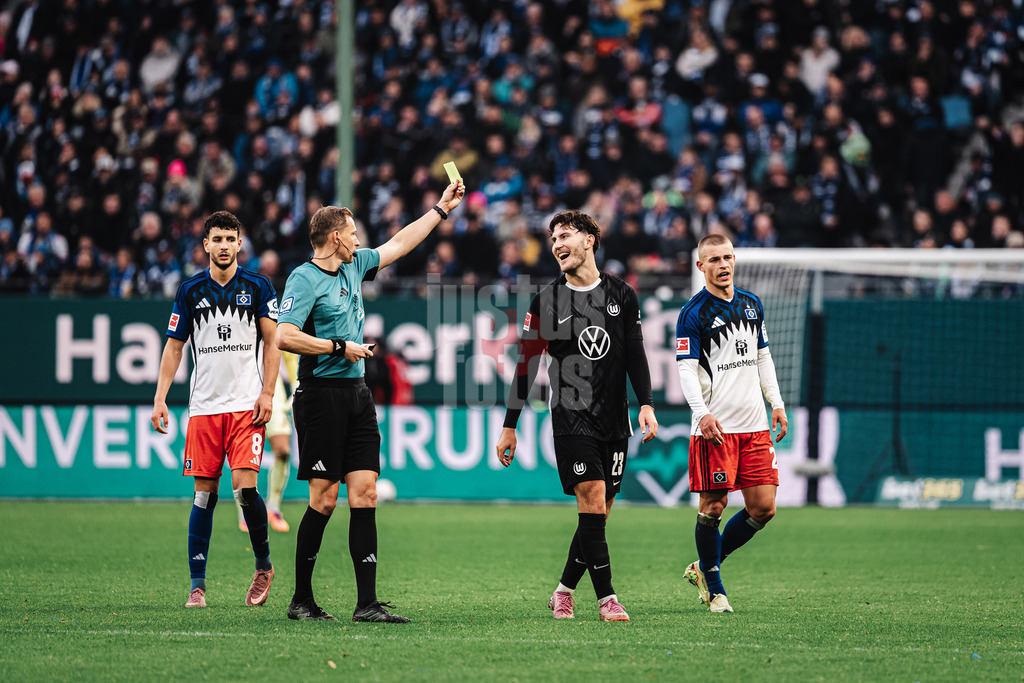 Fußball | Männer | Saison 2025/2026 | 1. Fußball-Bundesliga | 8. Spieltag | Hamburger SV vs. VfL Wolfsburg | 25.10.2025 | v.l. Schiedsrichter Martin Petersen zeigt Jonas Older Wind (#23, VfL Wolfsburg) die Gelbe Karte