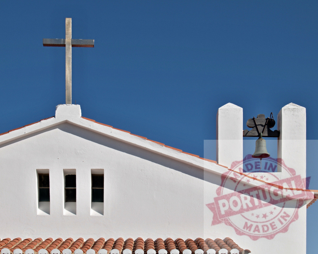 White church roof showing cross and bell against blue sky | White church roof with a cross and bell tower under a clear blue sky - Realized with Pictrs.com