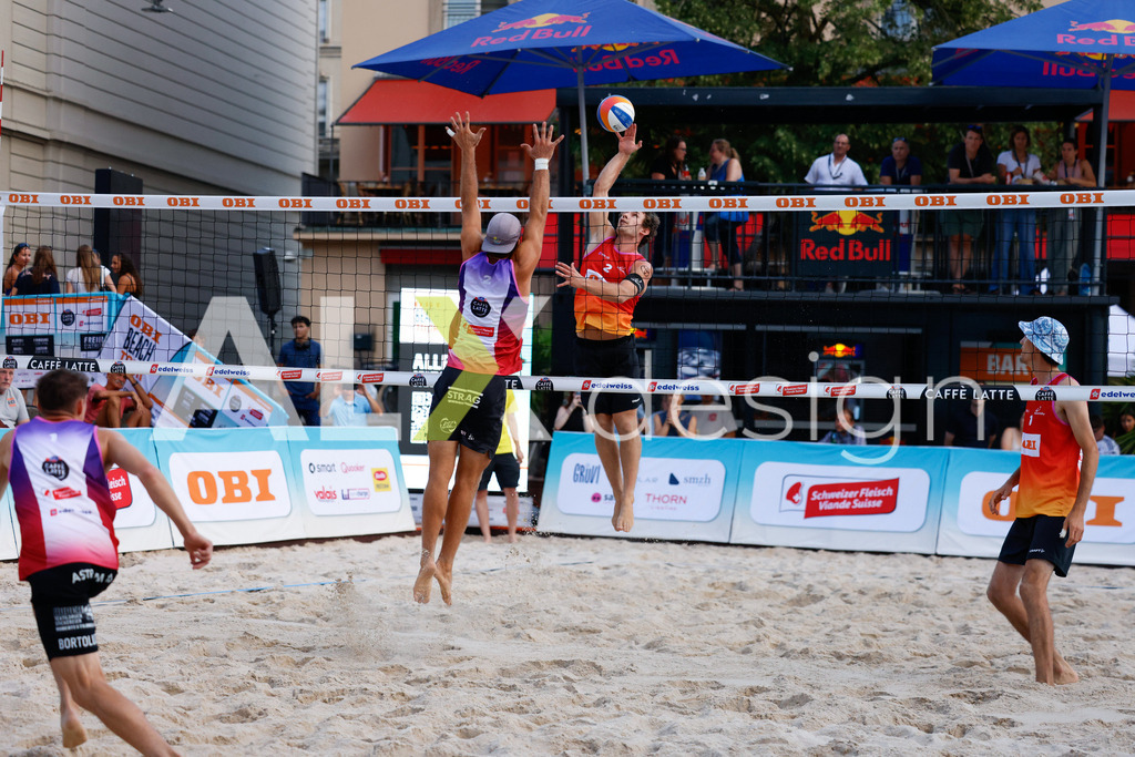 Obi BeachTour 2026 - Basel | BASEL, SWITZERLAND - JULY 17: YVES HAUSSENER (SUI) attack / spike against GAÉTAN JAUFFRET (SUI) block during the Obi BeachTour 2026 match between HAGENBUCH / HAUSSENER (SUI) and BORTOLUZZI / JAUFFRET (SUI) at Barfüsserplatz on July 17, 2026 in Basel, Switzerland. - Realisiert mit Pictrs.com
