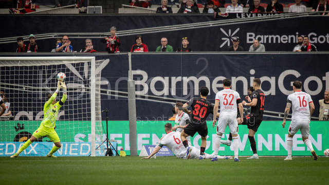 German Bundesliga, Bayer 04 Leverkusen vs. FC Augsburg, 18.04.2026 | LEVERKUSEN, GERMANY - APRIL 18, 2026 :  Keeper Finn Dahmen (FC Augsburg, 1) saves a shoot by Ibrahim Maza (Bayer 04 Leverkusen, 30) during the German Bundesliga match on gameday 30 between Bayer 04 Leverkusen vs. FC Augsburg at BayArena on April 18, 2026 in Leverkusen, Germany. DFL REGULATIONS PROHIBIT ANY USE OF PHOTOGRAPHS AS IMAGE SEQUENCES AND/OR QUASI-VIDEO.