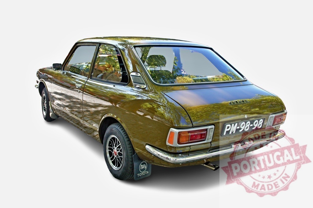 Classic Toyota Corolla is parked, showing its rear part | Vintage bronze Toyota Corolla parked and showing its rear, a nostalgic view of Japanese automotive history - Realized with Pictrs.com