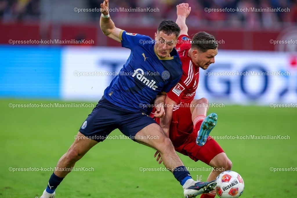F9510042601076 | 10.04.2026, Fußball, Fortuna Düsseldorf - Holstein Kiel, 2. Fußball Bundesliga, Herren, Merkur Spiel-Arena, 29. Spieltag, Saison 2025 2026: Florent Muslija&nbsp;(Fortuna Düsseldorf #24) verletzt sich im Zweikampf gegen  Adrián Kaprálik&nbsp; (Holstein Kiel #20)  DFB regulations prohibit any use of photographs as image sequences and or quasi-video.