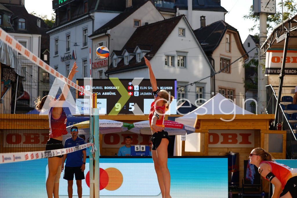 Obi BeachTour 2026 - Basel | BASEL, SWITZERLAND - JULY 17: LINDA ABBÜHL (SUI) attack / spike against ELIN SHANA KLUSER (SUI) block during the Obi BeachTour 2026 match between BOSSART / ABBÜHL (SUI) and KLUSER / SCHWAB (SUI) at Barfüsserplatz on July 17, 2026 in Basel, Switzerland. - Realisiert mit Pictrs.com