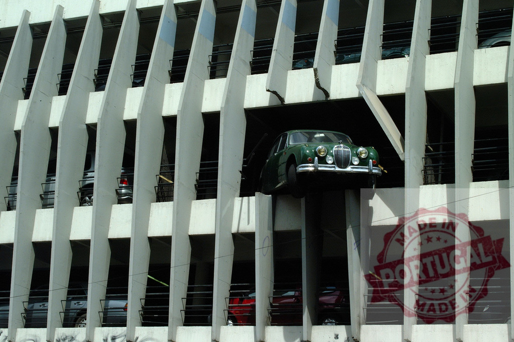 Vintage Jaguar breaking out of a parking garage | Green Jaguar breaking out of a parking garage, concept of freedom and breaking the rules - Realized with Pictrs.com