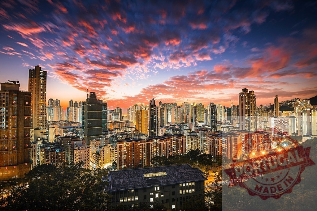 Hong Kong cityscape buildings illuminating colorful sunset sky | Hong Kong buildings illuminating the metropolitan skyline against a vibrant, dramatic sunset - Realized with Pictrs.com