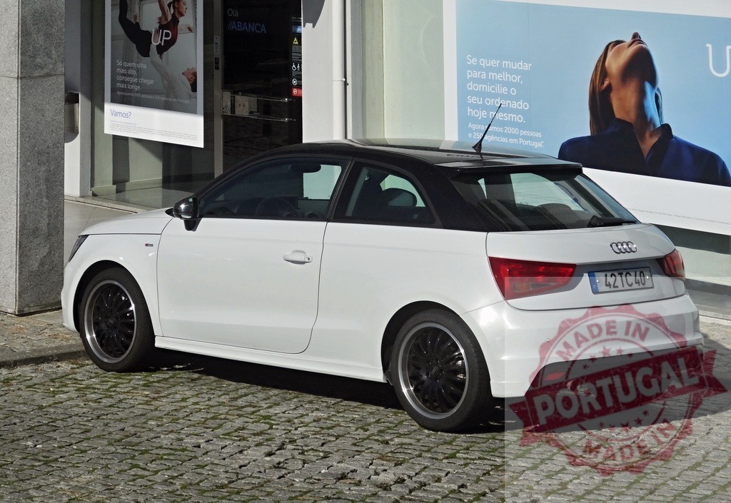 White Audi A1 hatchback parked on cobblestone street | White Audi A1 car with black roof parked on an urban cobblestone street - Realized with Pictrs.com
