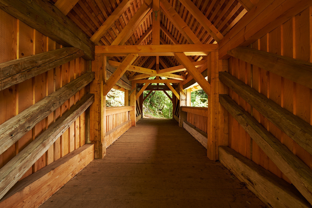 Kommabruecke | Hittisau, Austria - August 06, 2014: Kommabruecke,  eine denkmalgeschützte gedeckte Holzbrücke über die Bolgenach, um 1700 gebaut. - Realisiert mit Pictrs.com