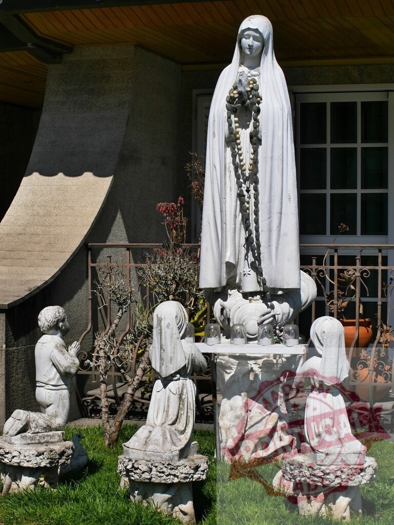 Our Lady of Fatima outdoor shrine with children praying | Our Lady of Fatima sculpture with rosaries surrounded by kneeling children statues in a garden - Realisiert mit Pictrs.com