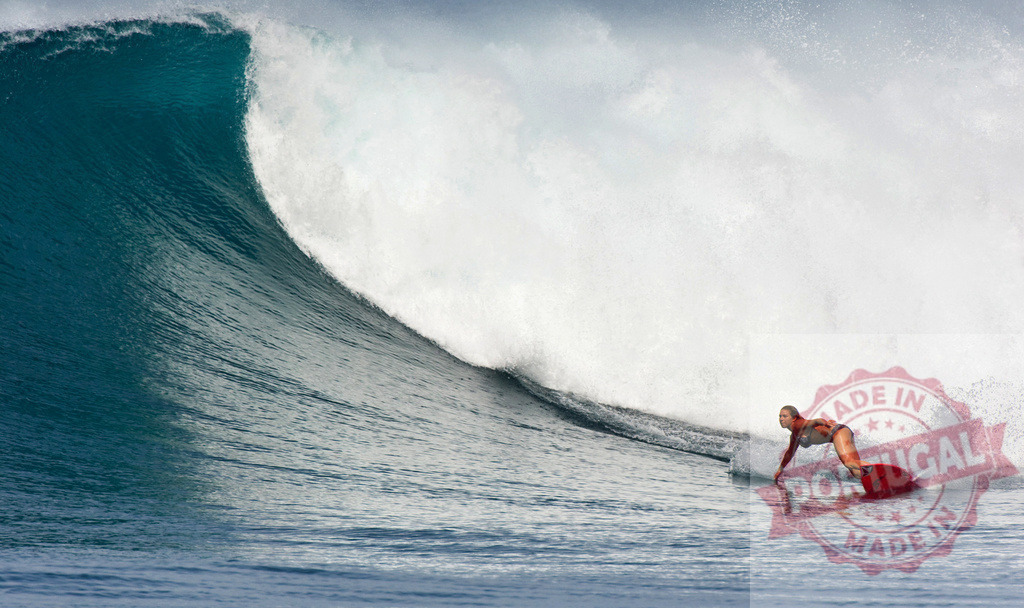 Female surfer riding a powerful ocean wave | Professional surfer riding a big wave in the ocean - Realized with Pictrs.com