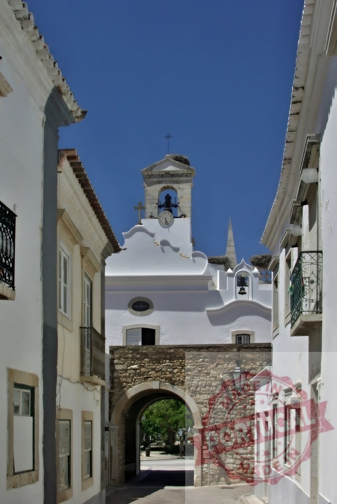 Arco da Vila archway revealing bell tower in Faro, Portugal | Historic Arco da Vila archway opening to a traditional church bell tower in Faro - Realized with Pictrs.com