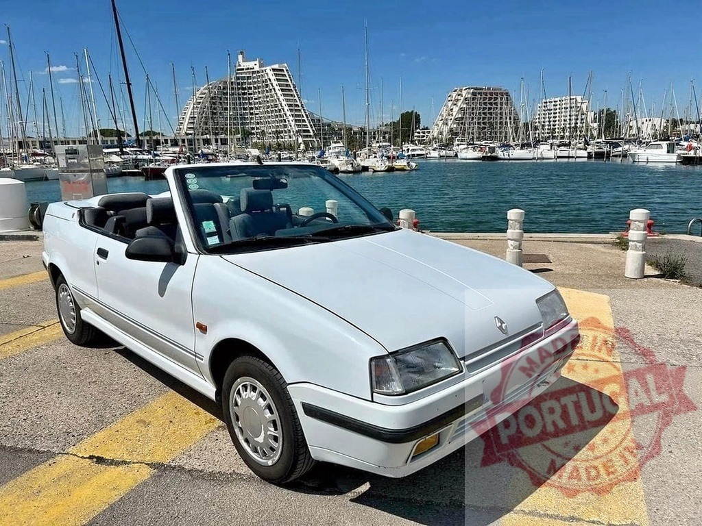 Renault 19 cabriolet parked at La Grande Motte marina | White classic convertible car parked by the harbor with boats and famous architecture - Realized with Pictrs.com
