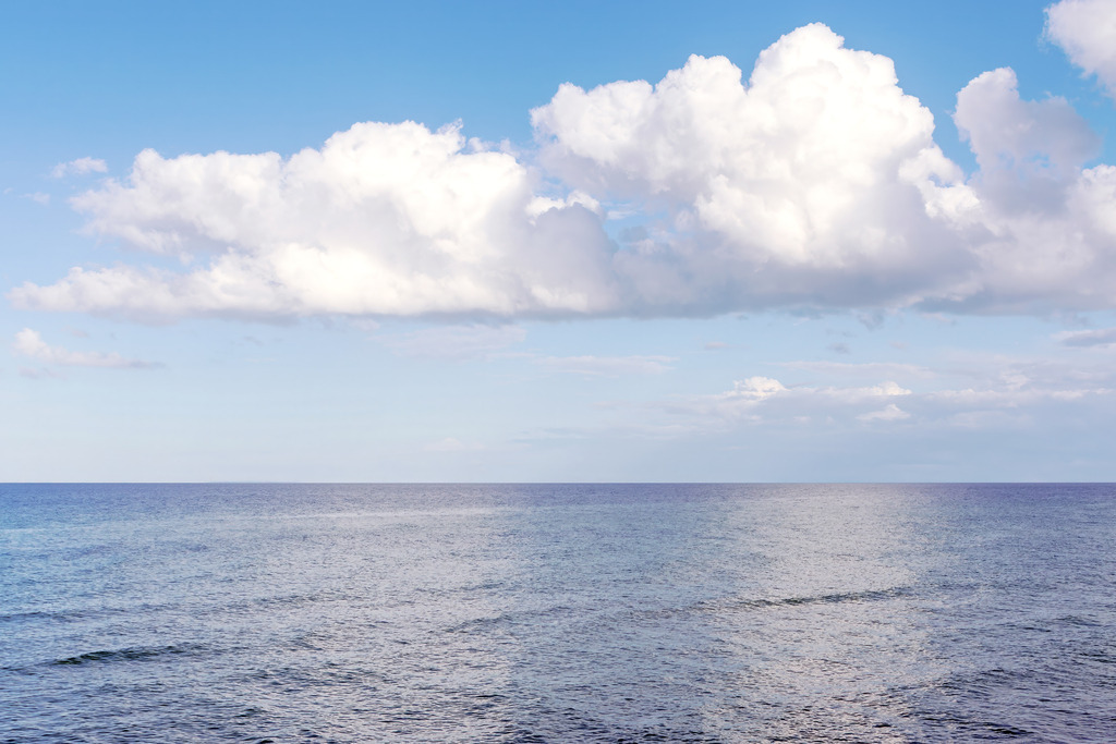 Himmel & Meer – Weite unter Wolkenlicht | Dieses Motiv zeigt die weite Fläche des Meeres unter einem hellen Himmel, in dem große, weiche Wolken über der Horizontlinie schweben. Das Licht spiegelt sich dezent auf der Wasseroberfläche und verleiht der Szene eine ruhige, klare Atmosphäre. Die ausgewogene Komposition aus Himmel und Meer erzeugt ein Gefühl von Offenheit, Leichtigkeit und stiller Weite. Als Wandbild erhältlich auf Acrylglas und weiteren hochwertigen Materialien.