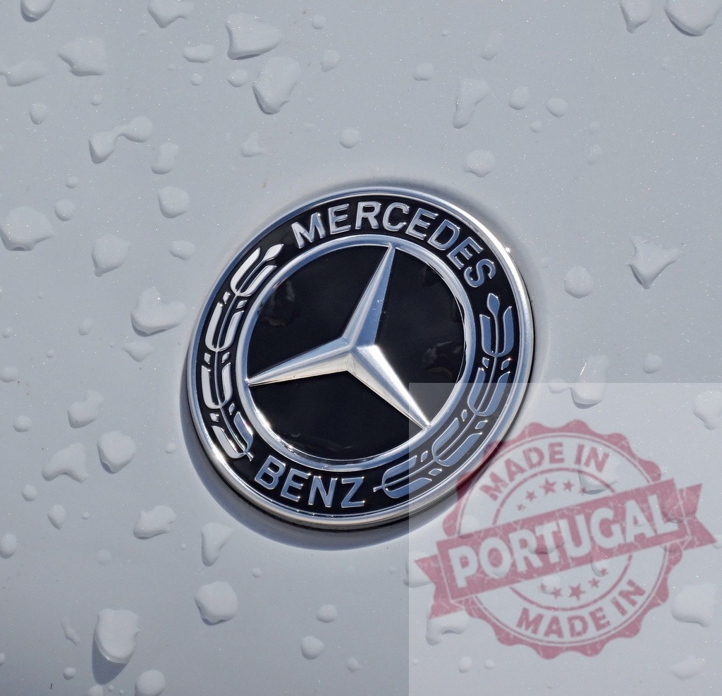 Mercedes-Benz emblem with raindrops on white car paint | Mercedes-Benz logo showing a three-pointed star with water drops on a vehicle surface - Realisiert mit Pictrs.com