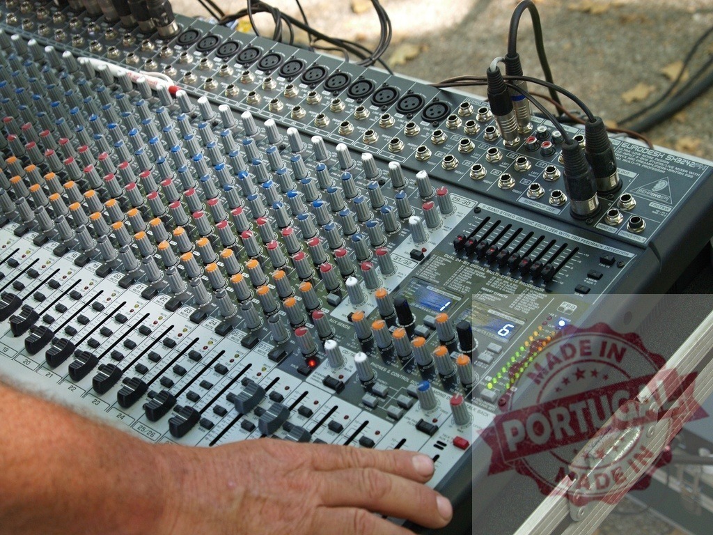 Sound engineer operating mixing console during event | Hand adjusting faders and knobs on a professional audio mixer - Realisiert mit Pictrs.com