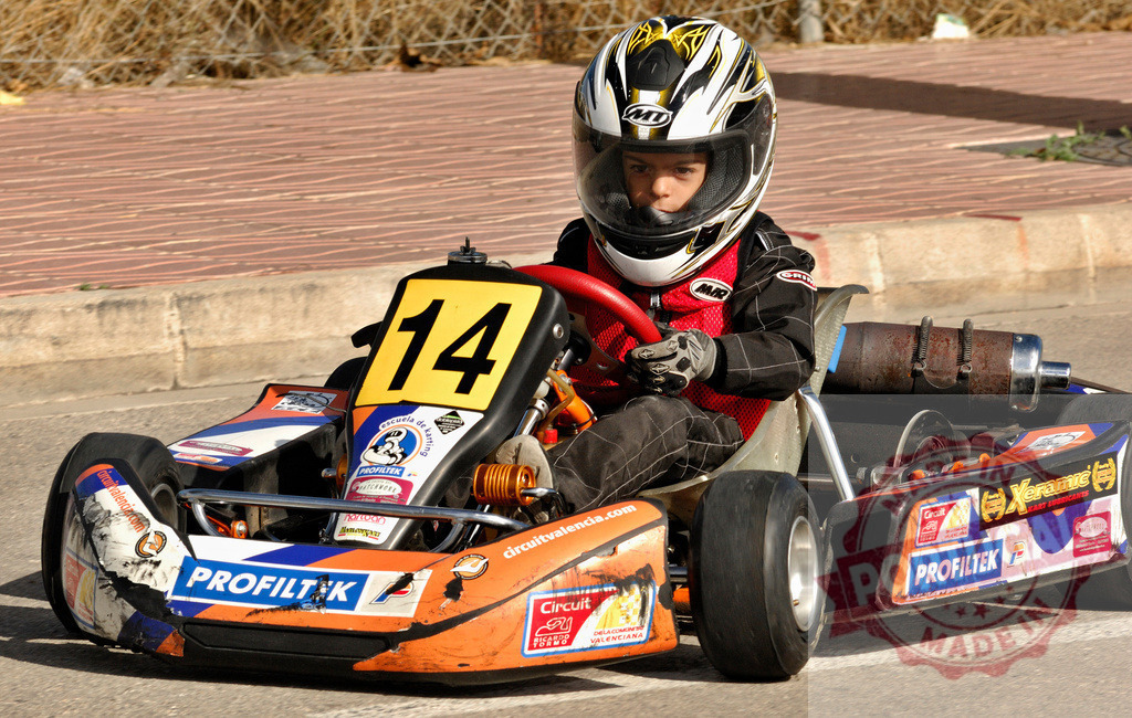 Young kart racer driving go-kart on a circuit | Young pilot driving go-kart on a karting track during a sunny day - Realisiert mit Pictrs.com