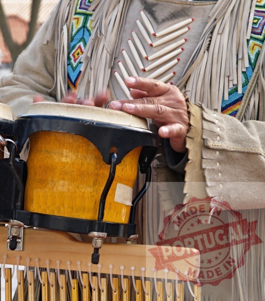 Street musician playing bongo drums wearing traditional native american clothes | Street musician playing traditional music with bongo drums and native american clothes - Realized with Pictrs.com