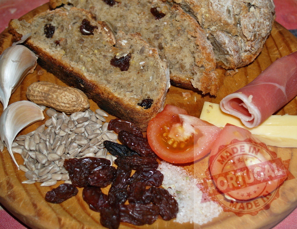 Rustic bread and charcuterie board with fresh ingredients | Rustic wooden board displaying a variety of fresh ingredients for a snack - Realized with Pictrs.com