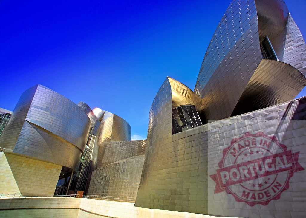 Guggenheim Museum Bilbao with titanium architecture against blue sky. Spain - Bilbao | Guggenheim Museum Bilbao showcasing avant-garde deconstructivism and reflective titanium curves under a clear sky - Realisiert mit Pictrs.com