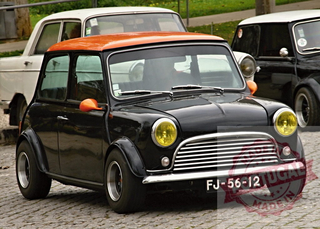 Classic Mini Cooper parking on cobblestone street | Customized black Mini Cooper with orange roof parked on a cobblestone street - Realized with Pictrs.com