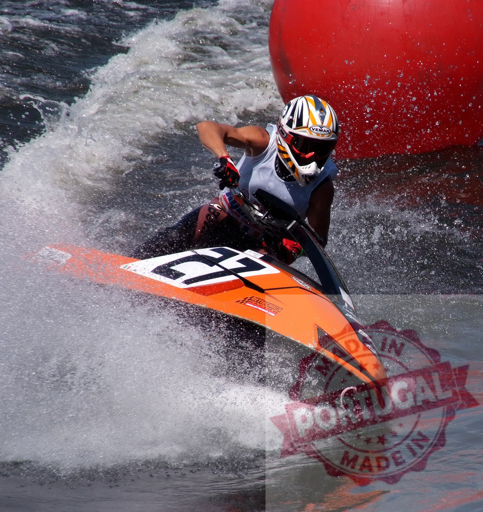 Pilot riding jet ski during competition | Jet ski pilot competing in a race, making a turn at high speed - Realized with Pictrs.com