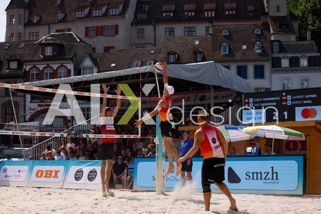 Obi BeachTour 2026 - Basel | BASEL, SWITZERLAND - JULY 19: LAURENZ LEITNER (AUT) attack / spike against SIMON HAGENBUCH (SUI) block during the Obi BeachTour 2026 match between HAGENBUCH / HAUSSENER (SUI) and LEITNER / KINDL (AUT) at Barfüsserplatz on July 19, 2026 in Basel, Switzerland. - Realisiert mit Pictrs.com
