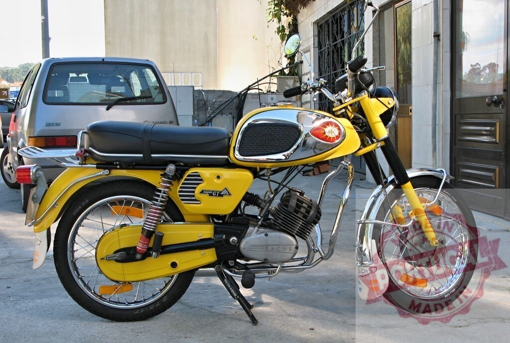 Yellow Sachs Super GT Motorcycle Parked on Street | Classic Sachs Super GT motorcycle parked on a street, showcasing its vintage design and vibrant yellow color - Realized with Pictrs.com