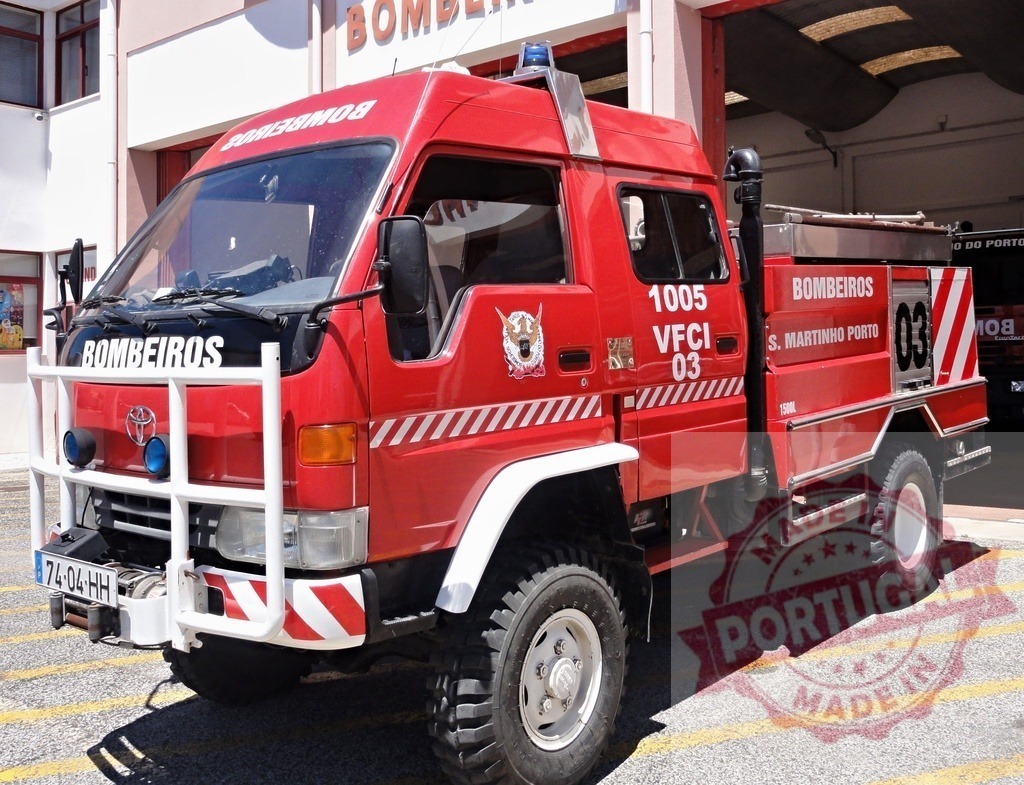 Red Bombeiros fire truck ready for emergency in Portugal | Red Toyota Bombeiros fire truck standing outside a fire station, ready for emergency response - Realized with Pictrs.com