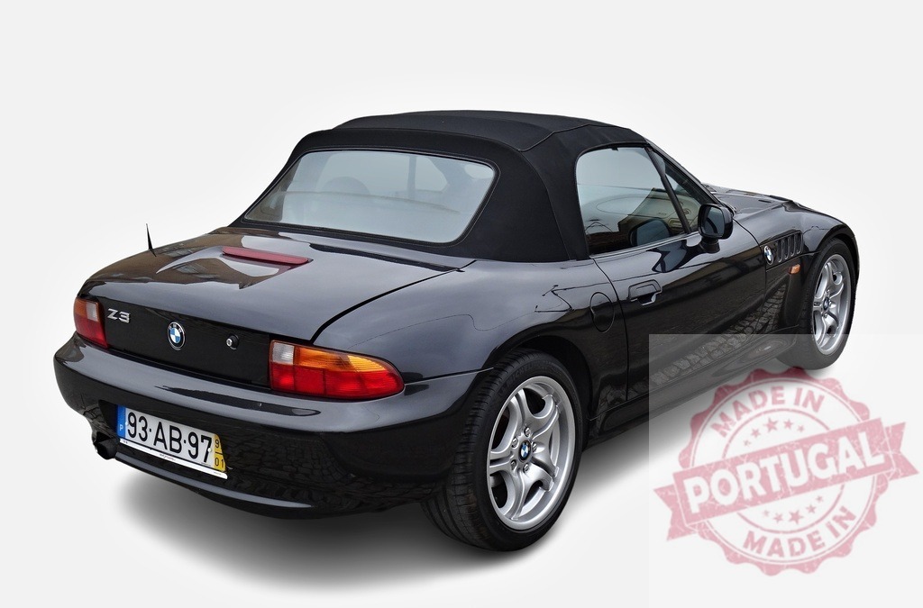 Rear view of a parked black BMW Z3 convertible with soft top | Black BMW Z3 convertible with soft top parked and showing rear - Realized with Pictrs.com