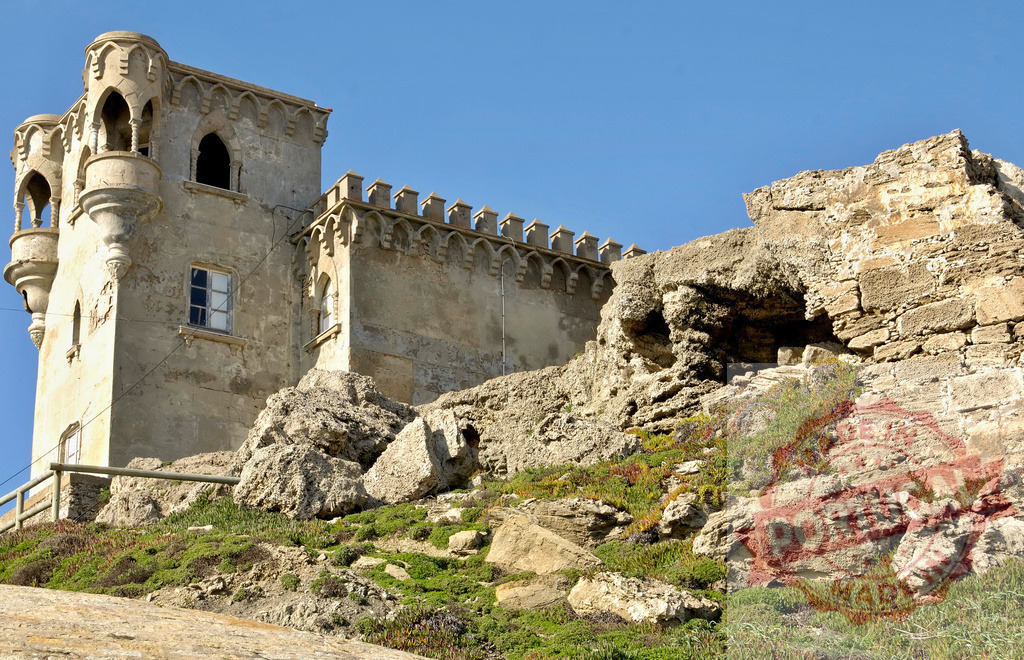 Castillo de Santa Catalina historic coastal fortress in Tarifa Spain. Espana - Cadiz | Castillo de Santa Catalina standing on rugged rocky headland under a clear blue sky - Realized with Pictrs.com