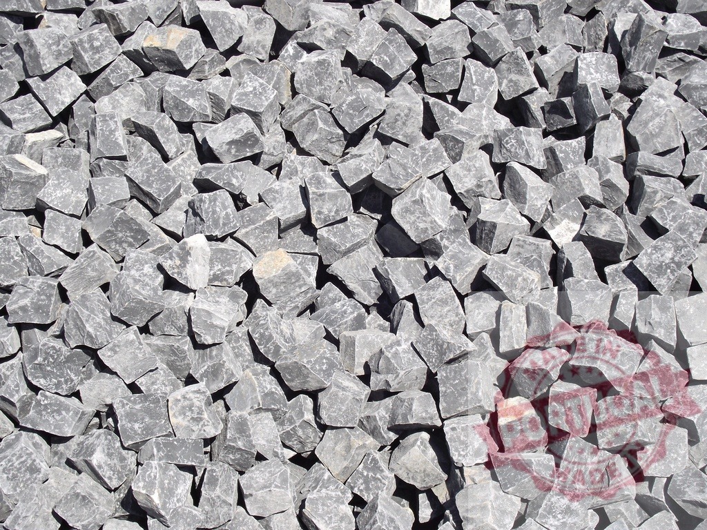 Pile of crushed gray stones forming a rough texture | Close-up view of a pile of crushed gray stones, creating a rough and uneven textured surface - Realized with Pictrs.com