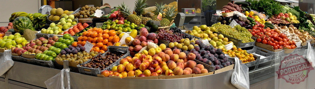 Fresh fruits and vegetables displaying variety at market stall | Colorful market stall overflowing with ripe fruits and vegetables for sale - Realized with Pictrs.com