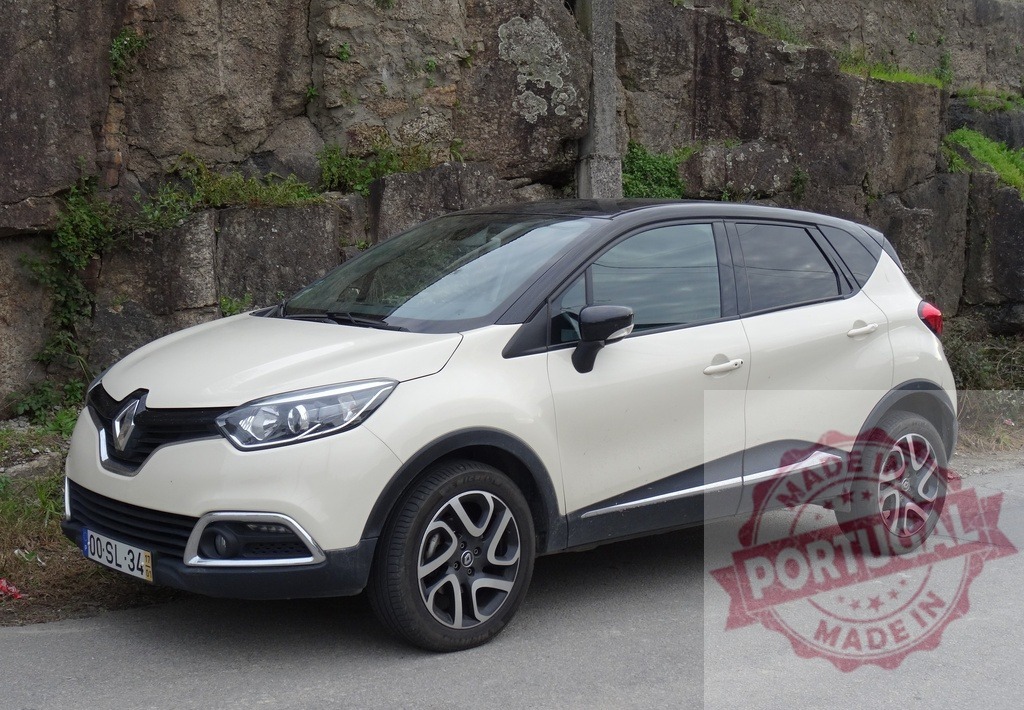 White Renault Captur crossover car parking on road | Renault Captur compact SUV vehicle parked on asphalt road in front of rock wall - Realized with Pictrs.com