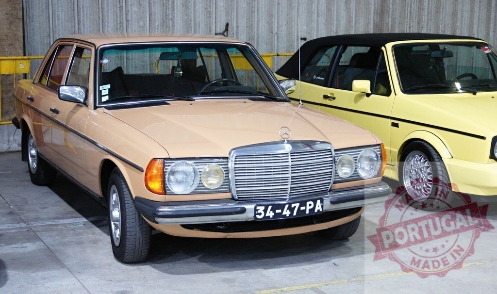 Mercedes-Benz W123 parked next to a Volkswagen Golf Cabriolet | Classic Mercedes-Benz W123 sedan parked in a garage next to a yellow Volkswagen Golf Cabriolet - Realized with Pictrs.com
