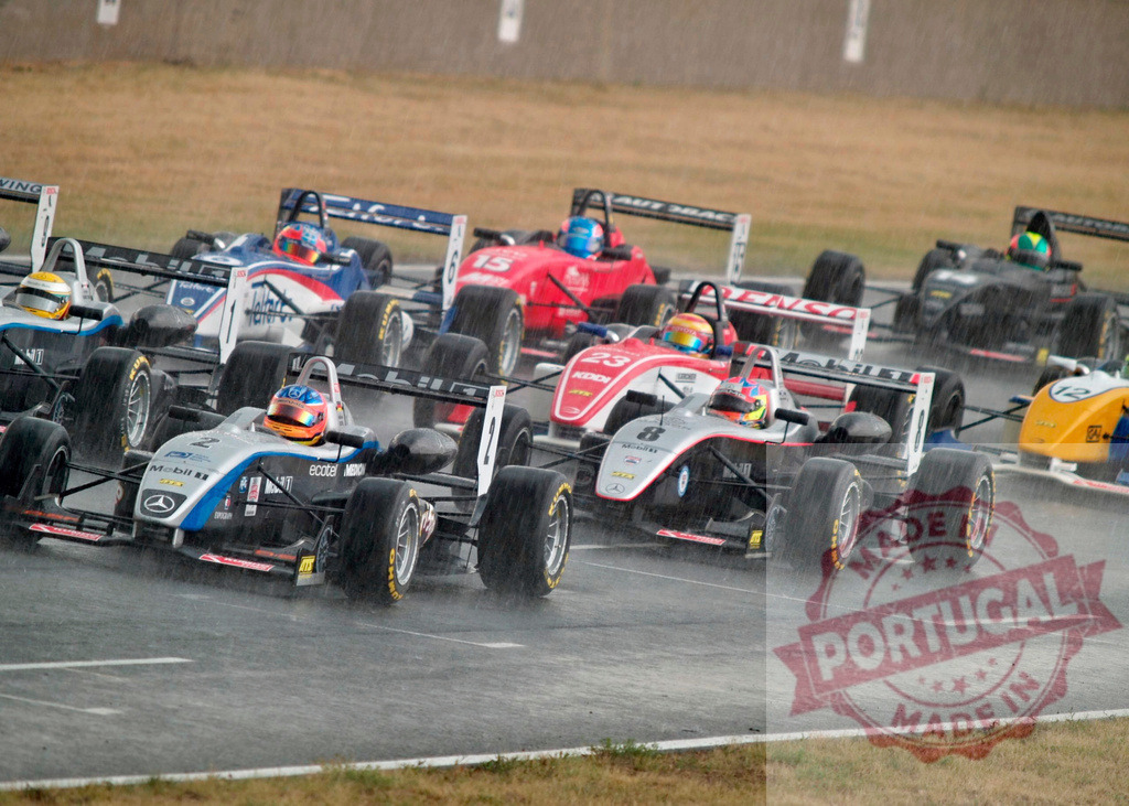 Formula racing cars competing on wet track in rain | Formula race cars speeding on a rain-soaked circuit during an intense competition - Realized with Pictrs.com