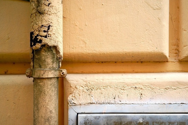 DSC06860 | Abflussrohr, senkrecht, hell-orange bemalt vor hell-rosa Steinwand - Realisiert mit Pictrs.com