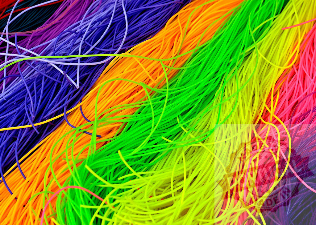 Colorful silicone rubber bands creating a vibrant and playful texture | Colorful silicone rubber bands forming a vibrant and playful textured background - Realisiert mit Pictrs.com