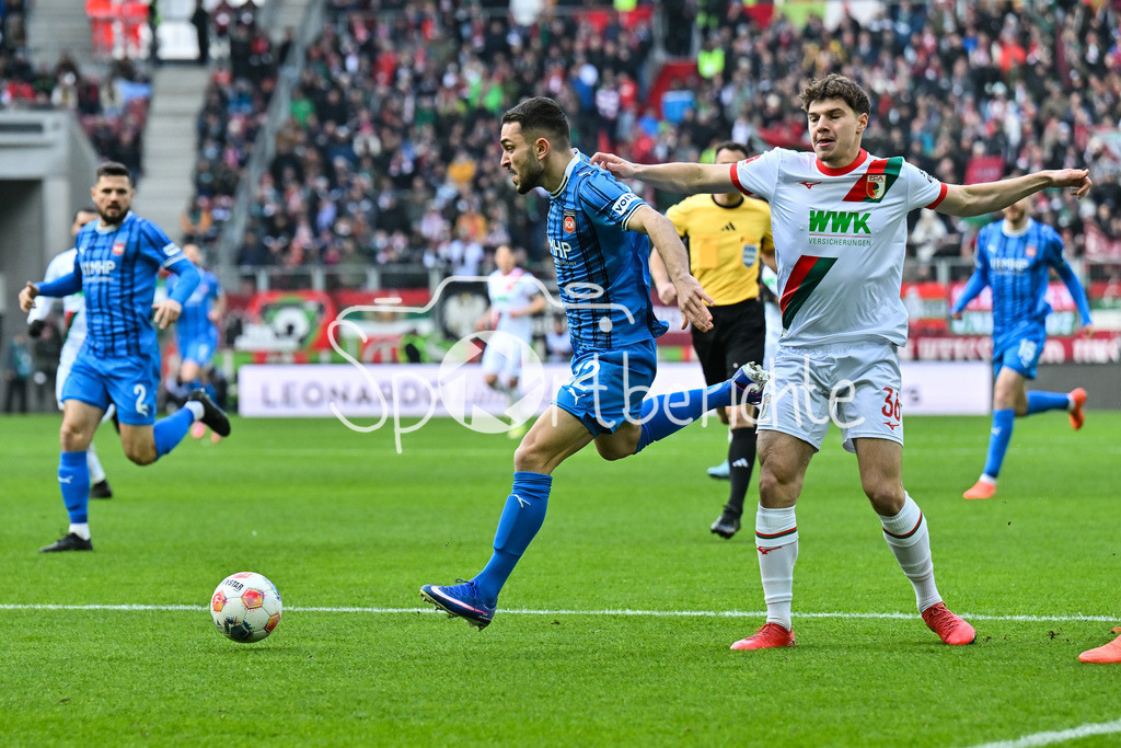 FC Augsburg - 1. FC Heidenheim | AUGSBURG, GERMANY - 15. FEBRUARY: im DUell Arijon IBRAHIMOVIC (1. FC Heidenheim 22) und Mert KOEMUER (KÖMÜR, KOMUR, FC Augsburg 36) während dem Bundesligamatch zwischen dem FC Augsburg und dem 1. FC Heidenheim am 22. Spieltag in der WWK-Arena / DFL REGULATIONS PROHIBIT ANY USE OF PHOTOGRAPHS AS IMAGE SEQUENCES AND/OR QUASI-VIDEO