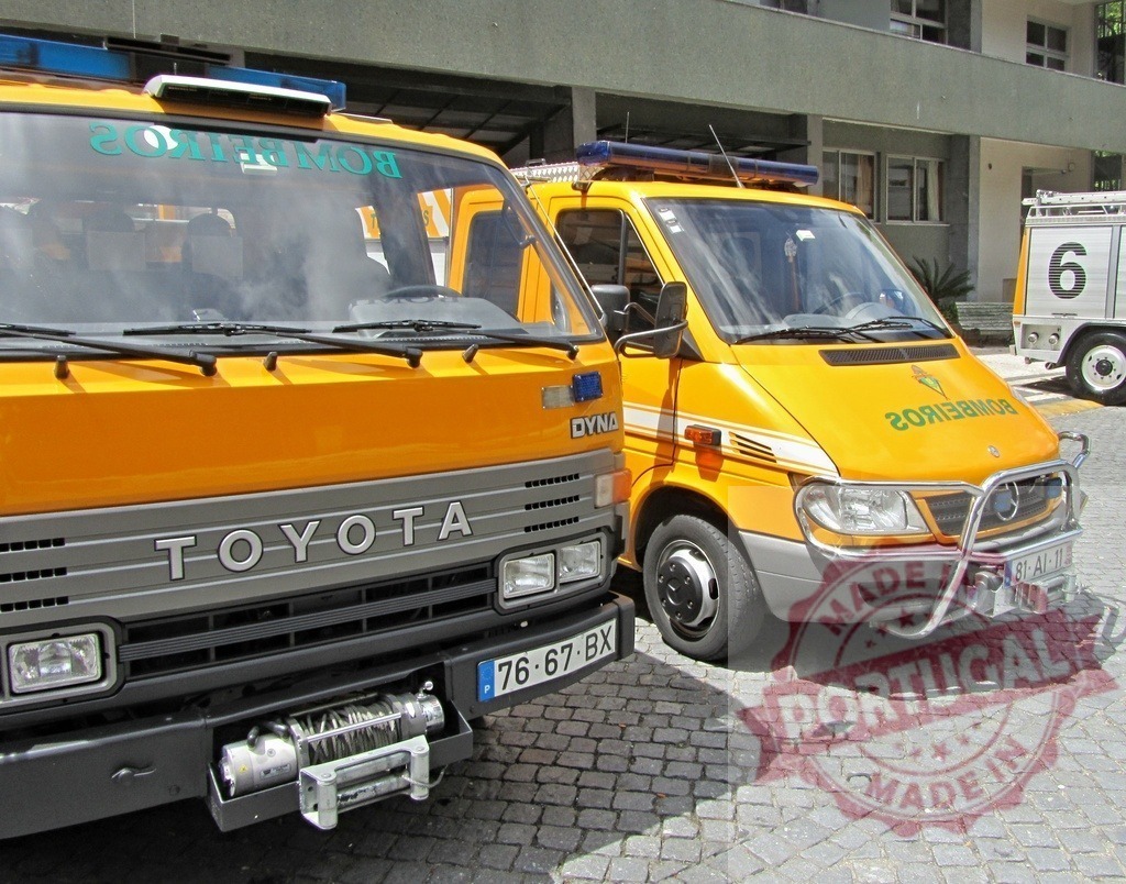 Toyota and Mercedes Benz fire trucks parked on cobblestones | Two yellow fire service vehicles standing ready for emergency response - Realized with Pictrs.com