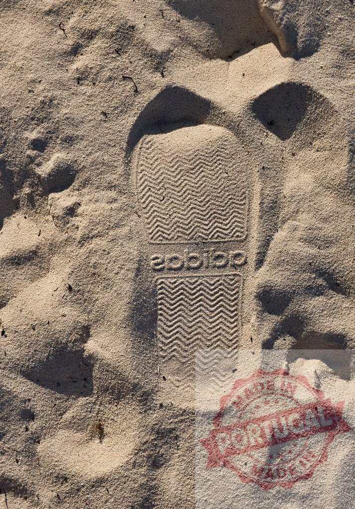 Adidas sandal footprint leaving a mark on sand | Adidas sandal leaving an imprint in the textured sand, symbolizing brand presence and summer leisure - Realized with Pictrs.com