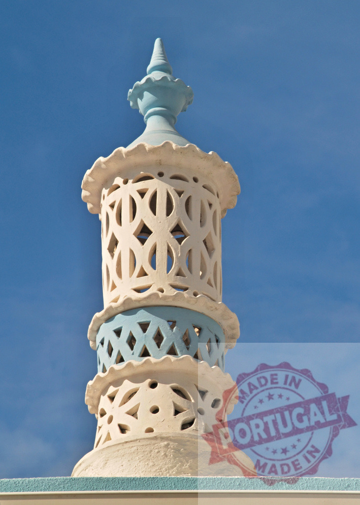 Algarve Moorish chimney with decorative rooftop architecture against blue sky | Decorative Moorish chimney structure featuring intricate details against a clear blue sky - Realized with Pictrs.com