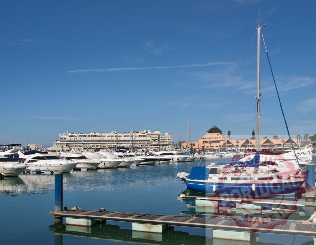 Vilamoura marina in Algarve, Portugal with yachts | Yachts and sailboats moored in Vilamoura marina under a clear blue sky - Realized with Pictrs.com