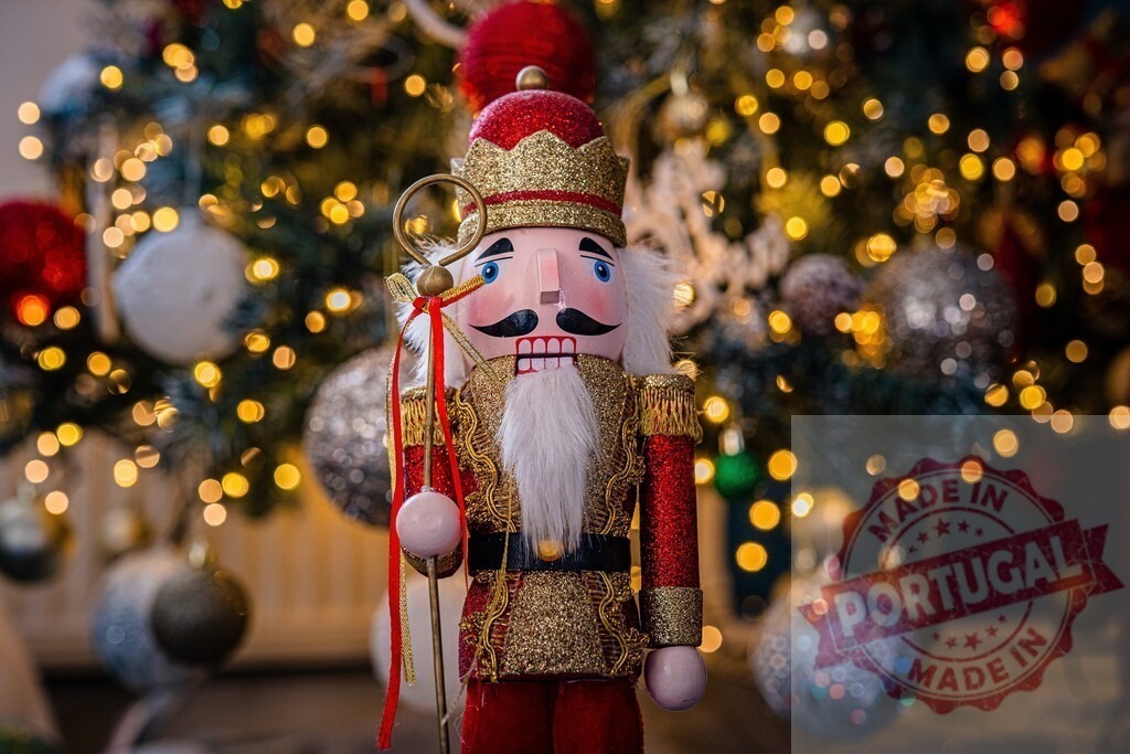 Traditional wooden nutcracker holding scepter standing in front of decorated Christmas tree | Christmas nutcracker toy soldier holding a scepter standing in front of a decorated and illuminated Christmas tree, celebrating Christmas holidays - Realized with Pictrs.com
