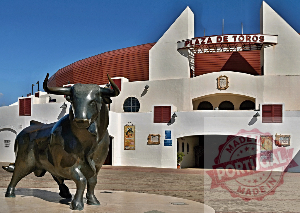 Bull statue guarding Plaza de Toros entrance in Spain | Bronze bull statue standing in front of traditional Spanish bullring entrance - Realized with Pictrs.com