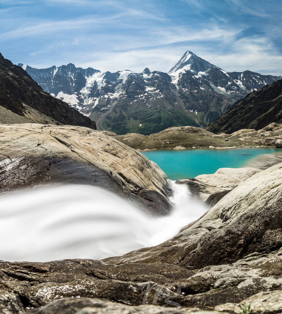 Mountain Stream above emerald blue Blauseeli | Captured while hiking with a friend in Lötschental, Valais. In the Background you can see the northside of Bietschhorn. The effect is created by a ND-Filter to take a longexposure-picture during bright daylight. - Realisiert mit Pictrs.com