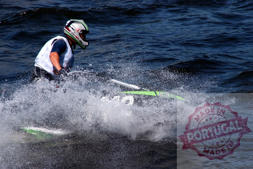 Pilot riding jet ski splashing water during competition | Professional pilot competing in a jet ski race, creating a splash of water - Realisiert mit Pictrs.com