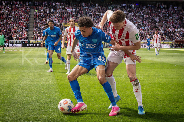 German Bundesliga,  1. FC Koeln - Bayer 04 Leverkusen, 25.04.2026 | KOELN, GERMANY - APRIL 25, 2026 :  Montrell Amare Culbreath  (Bayer 04 Leverkusen, 42), Marius Buelter (Bülter, Bulter, 1. FC Koeln, 30) during the German Bundesliga match on gameday 31 between 1. FC Koeln - Bayer 04 Leverkusen at RheinEnergieSTADION on April 25, 2026 in Koeln, Germany. DFL REGULATIONS PROHIBIT ANY USE OF PHOTOGRAPHS AS IMAGE SEQUENCES AND/OR QUASI-VIDEO.