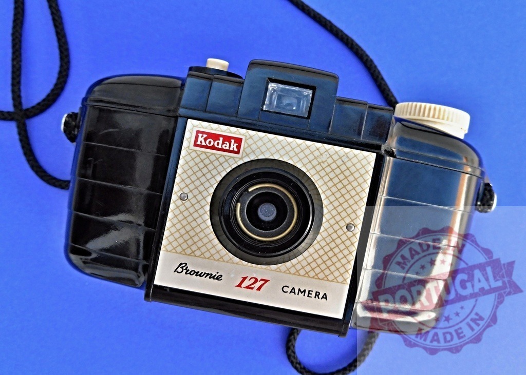 Kodak Brownie 127 vintage camera on blue background | Kodak Brownie 127 vintage roll film camera representing analog photography and retro technology - Realized with Pictrs.com
