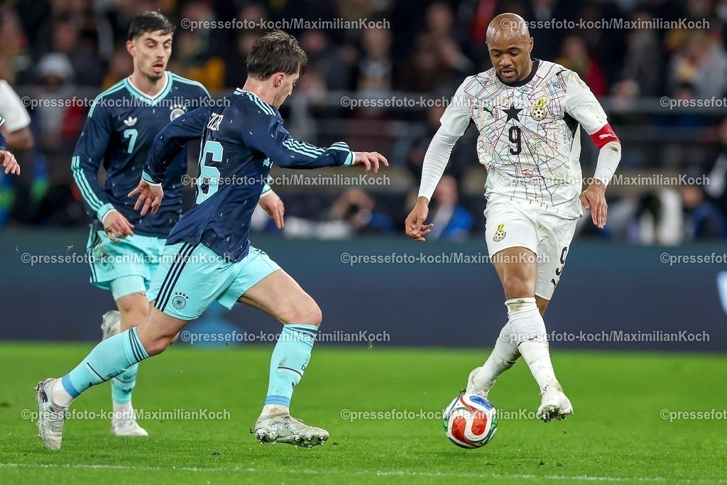 DFB30032600044 | 30.03.2026, Fußball, Länderspiel, Deutschland - Ghana, MHP-Arena (Stuttgart), Saison 2025 2026: Kai Havertz (GER #07) Angelo Stiller (GER #16) im Zweikampf gegen  Jordan Ayew (Ghana #9)  DFB regulations prohibit any use of photographs as image sequences and or quasi-video.