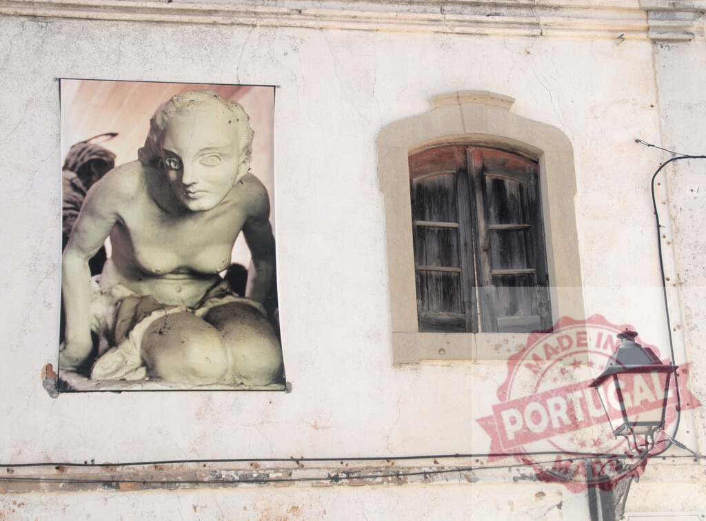 Surreal art poster on ancient building wall | Surreal art poster displaying a female figure attached to a weathered building wall - Realisiert mit Pictrs.com