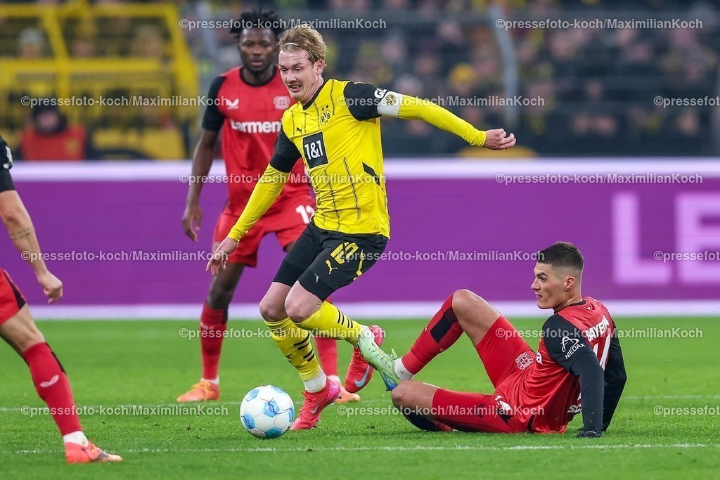 BVB10012501070 | 10.01.2025, Fußball, Borussia Dortmund - Bayer 04 Leverkusen, 1. Fußball Bundesliga, 16. Spieltag, Signal Iduna Park, Saison 2024 2025: Julian Brandt (BVB #10) im Zweikampf gegen Granit Xhaka (Bayer04 Leverkusen #34) , Edmond Tapsoba (Bayer04 Leverkusen #12) und Patrik Schick (Bayer04 Leverkusen #14)DFB regulations prohibit any use of photographs as image sequences and or quasi-video.